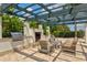 Outdoor kitchen and grill area with a fireplace and comfortable seating at 5130 Tidewater Preserve Blvd, Bradenton, FL 34208