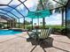 Covered patio with table and chairs next to the pool, offering shade and scenic views at 5130 Tidewater Preserve Blvd, Bradenton, FL 34208