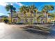 Front view of three-story building with three units and palm trees at 6315 Sunset Bay Cir, Apollo Beach, FL 33572