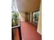 Spacious balcony with access to the condo unit and partial view of the lush landscaping at 6466 Seagull Dr # 323, Bradenton, FL 34210