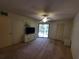 Spacious bedroom with carpeting, a ceiling fan, and sliding glass doors to a balcony at 6466 Seagull Dr # 323, Bradenton, FL 34210