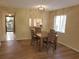 Bright dining area with wood table and chairs, and access to kitchen at 6466 Seagull Dr # 323, Bradenton, FL 34210