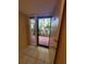 Bright entryway with tile floors and a door leading to a screened balcony at 6466 Seagull Dr # 323, Bradenton, FL 34210