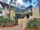 Condo building showcasing a two-story design with tropical landscaping at 6466 Seagull Dr # 323, Bradenton, FL 34210