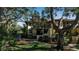 Condo building exterior showcasing landscaping and tree-lined walkway at 6466 Seagull Dr # 323, Bradenton, FL 34210