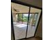 Spacious lanai with tiled floors and sliding glass doors offering scenic pond views at 6466 Seagull Dr # 323, Bradenton, FL 34210
