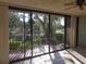 Living room with sliding glass doors leading to a scenic balcony overlooking a pond at 6466 Seagull Dr # 323, Bradenton, FL 34210