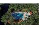 Community pool and spa surrounded by tropical landscaping at 6466 Seagull Dr # 323, Bradenton, FL 34210