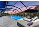 Covered patio with pool and comfortable seating for relaxation at 6741 Rookery Lake Dr, Bradenton, FL 34212