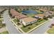 Aerial view of a neighborhood with a large pond, mature landscaping and tile roofs on each home at 6741 Rookery Lake Dr, Bradenton, FL 34212