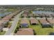 Aerial view of homes with screened in pools and lush landscaping in a well-maintained neighborhood at 6741 Rookery Lake Dr, Bradenton, FL 34212
