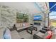 Covered patio with seating area, fireplace, and marble tile at 6741 Rookery Lake Dr, Bradenton, FL 34212