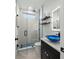 Bathroom featuring walk-in shower with glass door, sleek fixtures, floating shelves, and a blue glass sink at 6741 Rookery Lake Dr, Bradenton, FL 34212