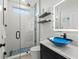 Modern bathroom features a glass shower with blue accents and stylish blue glass vessel sink at 6741 Rookery Lake Dr, Bradenton, FL 34212