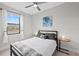 Neutral bedroom with a gray upholstered bed frame, ceiling fan, and plenty of natural light at 6741 Rookery Lake Dr, Bradenton, FL 34212