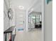 Bright entryway features wood-look flooring, geometric wall decor, and a view into a home office at 6741 Rookery Lake Dr, Bradenton, FL 34212