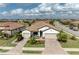 Aerial view of a single-story home with tile roof, landscaped yard, and paved driveway at 6741 Rookery Lake Dr, Bradenton, FL 34212