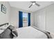 Bedroom with queen bed, window, and white closet doors at 6741 Rookery Lake Dr, Bradenton, FL 34212