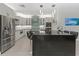 Sleek kitchen boasts stainless steel appliances, granite countertops, and elegant pendant lighting at 6741 Rookery Lake Dr, Bradenton, FL 34212
