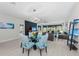 Open concept living area flows from living to dining, all with views of the pool at 6741 Rookery Lake Dr, Bradenton, FL 34212