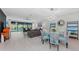 Open-concept living and dining area with light wood floors and pool view at 6741 Rookery Lake Dr, Bradenton, FL 34212