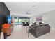 Bright, spacious living room with plush seating, modern decor, and view of outdoor pool at 6741 Rookery Lake Dr, Bradenton, FL 34212