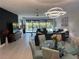 Spacious living area with stylish decor, modern lighting, and sliding glass doors to the pool at 6741 Rookery Lake Dr, Bradenton, FL 34212