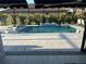Relaxing screened pool with a sun shelf and tiled water feature offers a private outdoor oasis at 6741 Rookery Lake Dr, Bradenton, FL 34212