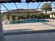 Relaxing screened pool with a sun shelf and tiled water feature offers a private outdoor oasis at 6741 Rookery Lake Dr, Bradenton, FL 34212