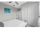 Bedroom with queen bed, white closet doors, and window at 6741 Rookery Lake Dr, Bradenton, FL 34212