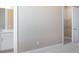 Bright bathroom with double vanity, white cabinets, and access to a walk in closet at 7661 Moonbeam Ave, Sarasota, FL 34241