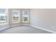 Bright bedroom with large windows offering a pleasant view and neutral walls and carpets at 7661 Moonbeam Ave, Sarasota, FL 34241