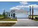Beautiful single-story home showcasing a three car garage and manicured front lawn at 7661 Moonbeam Ave, Sarasota, FL 34241