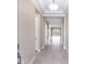 Bright hallway with light wood-look flooring and coffered ceiling leads to living areas at 7661 Moonbeam Ave, Sarasota, FL 34241