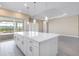 Modern kitchen with a spacious island, stainless appliances, and a view to the backyard at 7661 Moonbeam Ave, Sarasota, FL 34241