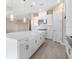 Modern kitchen featuring a spacious island, stainless steel appliances, and white cabinetry at 7661 Moonbeam Ave, Sarasota, FL 34241