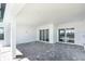 Spacious lanai with brick flooring and sliding doors with access to the backyard at 7661 Moonbeam Ave, Sarasota, FL 34241