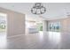 Bright, open-concept living area with an adjacent kitchen and sliding glass doors at 7661 Moonbeam Ave, Sarasota, FL 34241