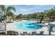 Inviting pool area with ample seating, surrounded by lush tropical landscaping and a relaxing atmosphere at 7661 Moonbeam Ave, Sarasota, FL 34241