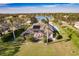 Aerial view of single-Gathering home with pool and lush landscaping at 22575 Morning Glory Cir, Bradenton, FL 34202