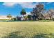 One-story house with palm trees and a large yard at 22575 Morning Glory Cir, Bradenton, FL 34202