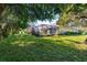 Relaxing backyard with screened pool area surrounded by trees at 11734 Hidden Forest Loop, Parrish, FL 34219