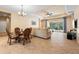 Casual dining area with wicker chairs and glass table, open floor plan at 11734 Hidden Forest Loop, Parrish, FL 34219