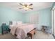 King-size bed, light blue walls, ceiling fan, and a bookcase at 5404 Carso Ter, North Port, FL 34286