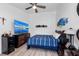 Bedroom with large TV, bed, and wall decor at 2209 Belleair Rd # C29, Clearwater, FL 33764