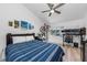 Bedroom with large TV, bed, and wall decor at 2209 Belleair Rd # C29, Clearwater, FL 33764