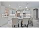 Elegant kitchen with white cabinets, quartz countertops, and an island with seating at 7521 Trillium Blvd, Sarasota, FL 34241