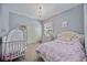 Charming bedroom with a crib and a queen bed at 7521 Trillium Blvd, Sarasota, FL 34241