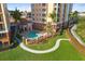 Community pool area with surrounding green space and walkway at 157 Tampa Ave # 707, Venice, FL 34285