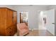 Guest bedroom with wood armoire and comfortable armchair at 157 Tampa Ave # 707, Venice, FL 34285